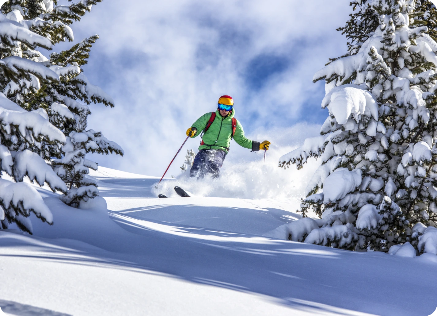 Here's an alt tag for the image: Skier carving powder snow in mountains.