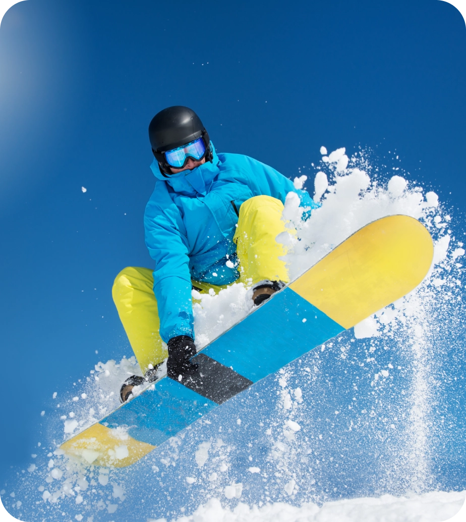 Snowboarder soaring through blue sky.