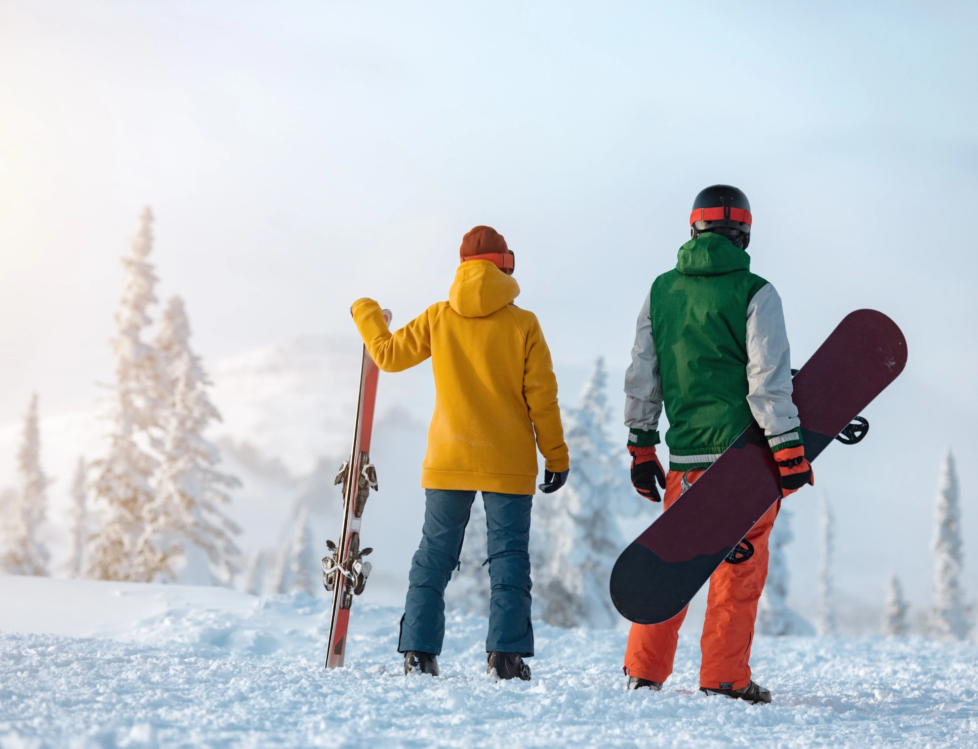 Skiers and snowboarder on snowy mountain.